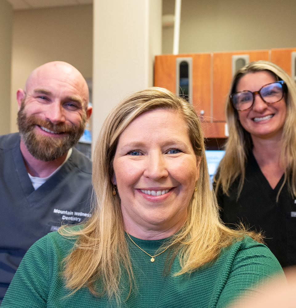 Dr. Yelle, staff member and a patient smiling together